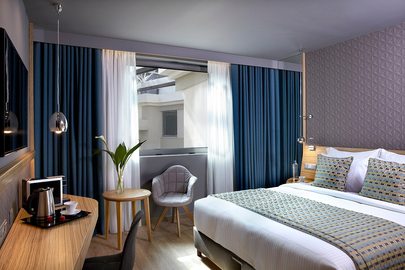 Standardzimmer im Wyndham Grand Athen mit Panoramafenster und Stadtblick